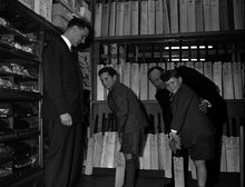 Load image into Gallery viewer, Peter May, England&#39;s Cricket Captain and Surrey player took a moment on a visit to the N.E.Blake &amp; Co. Sports Store on Minster Street in Reading to teach 11 year old, Nigel Goddard some batting tips whilst Stuart Surridge, the Surrey Captain and nine year old Roy Baylis looked on.  This photograph was published in the Berkshire Chronicle on 18 April 1958.